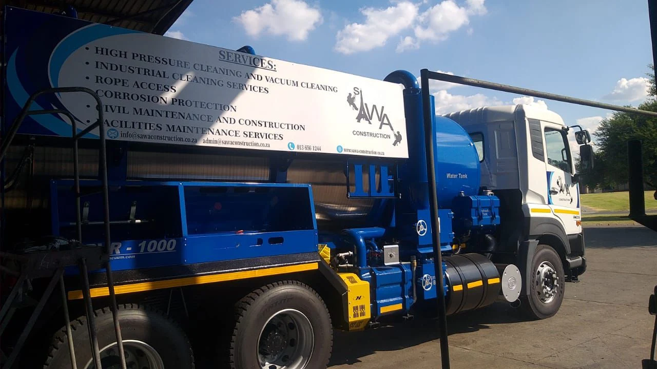 SAWA Construction HPVR-1000 vacuum truck on site performing industrial vacuuming services to remove toxic waste from a plant in South Africa.